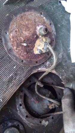 Underside of the fuel pickup plate. I broke the pickup line off trying to pull the plate up higher than one inch (not enough to see what was preventing it from coming out).