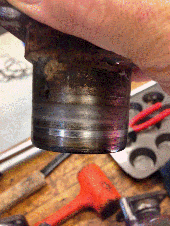 Here's the flange for the rear driveshaft. The area where the seal's lip made contact is well worn. The area where the felt ran is not too bad. I guess it stayed oil saturated over the years!