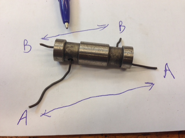 The lettered portions are attached and there is a chamfer on the side that the pen is pointing to.
